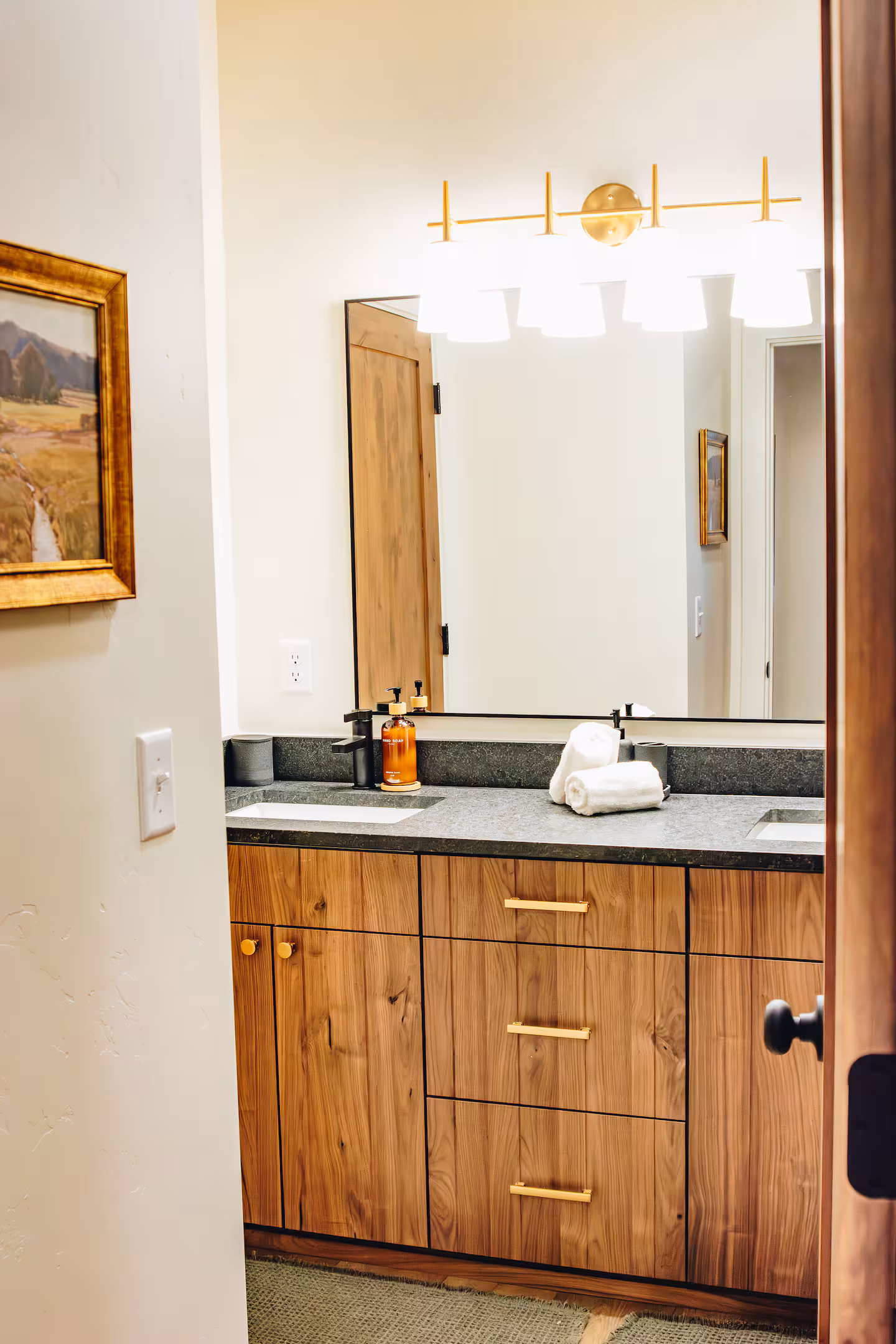 Walnut double vanity with brass hardware