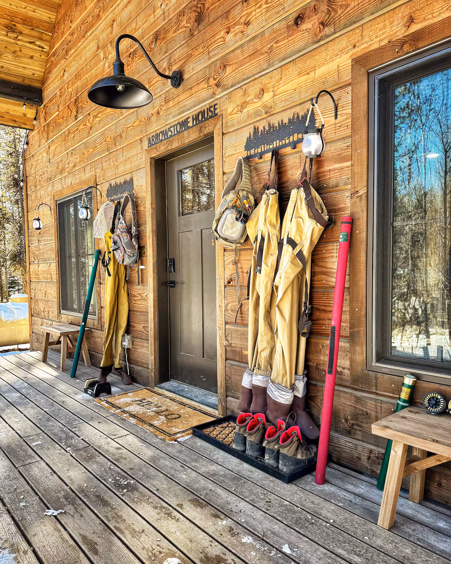 Front porch gear wall with waders, boots, nets and rod storage