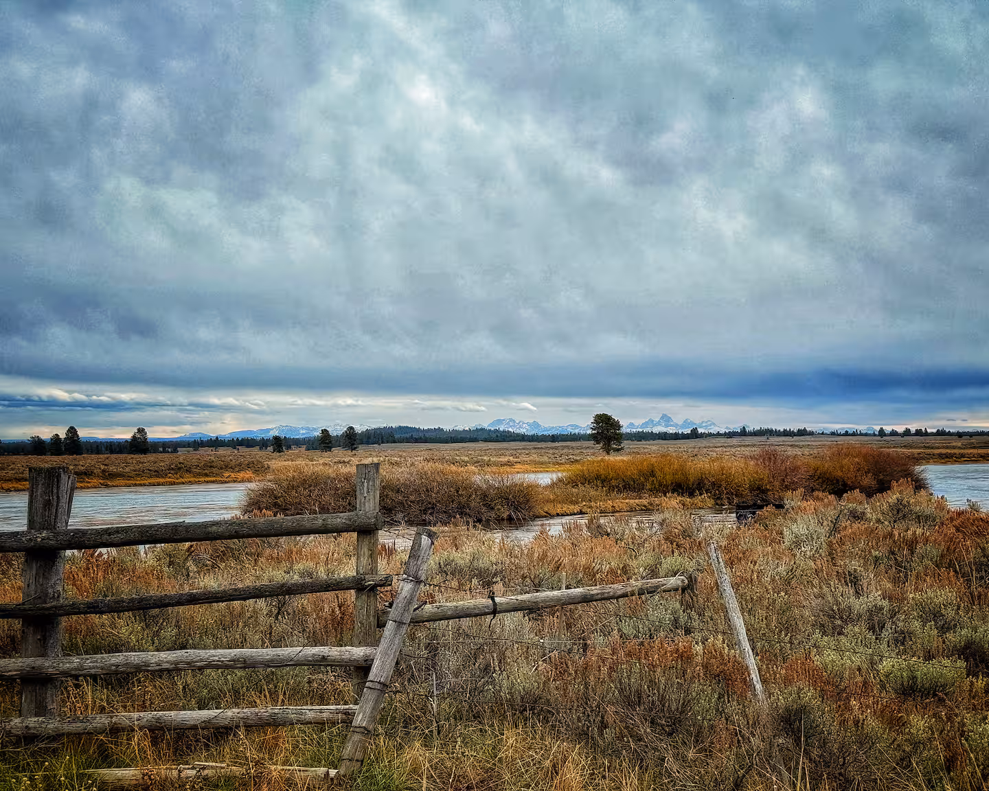 River bend through open meadow with the Tetons on the horizon